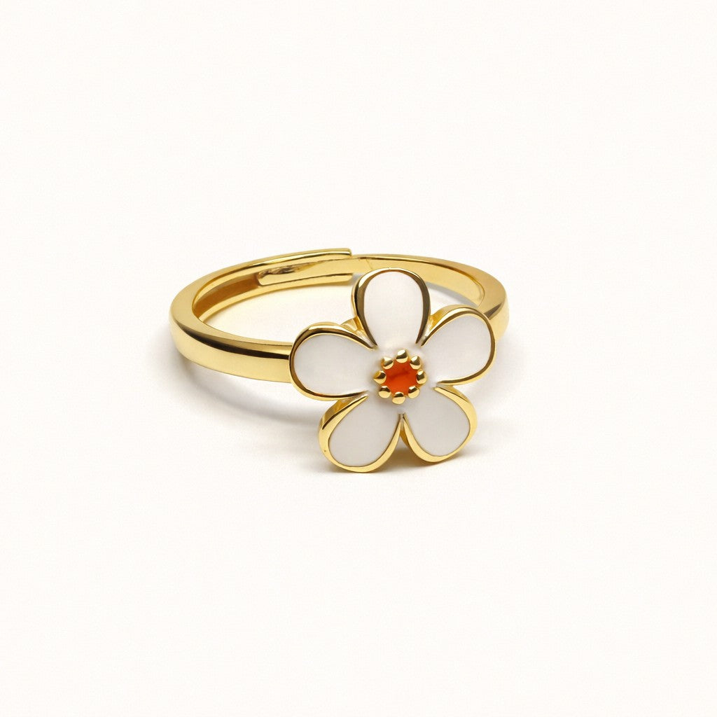 White Flower Spin Ring in gold-tone stainless steel with white enamel petals and a coral center, front view