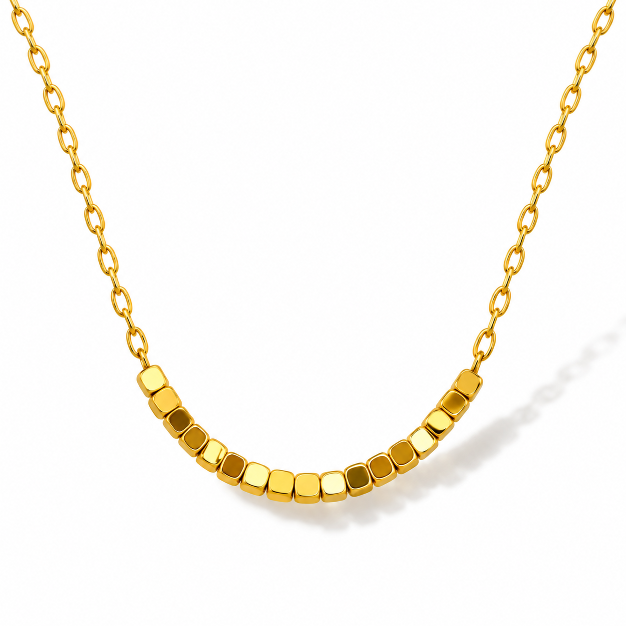 Golden Cubes necklace: a row of mirror-polished, gold-plated stainless steel cube beads on a fine gold link chain, shown on a white background.