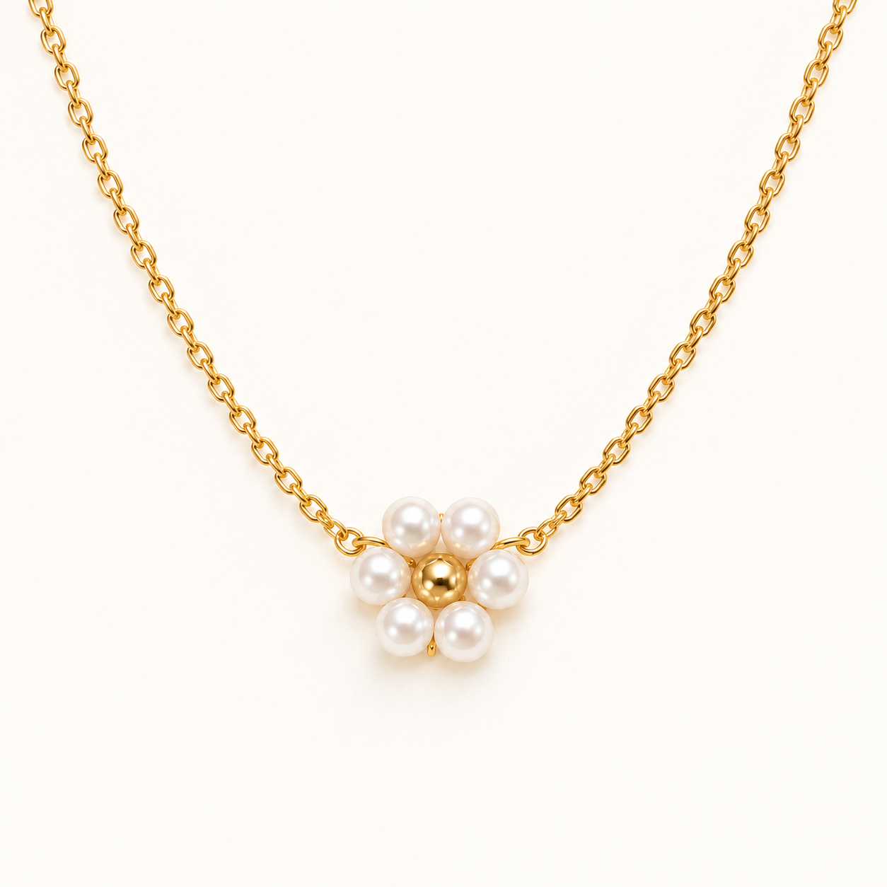 Gold necklace with a pearl flower pendant on a white background