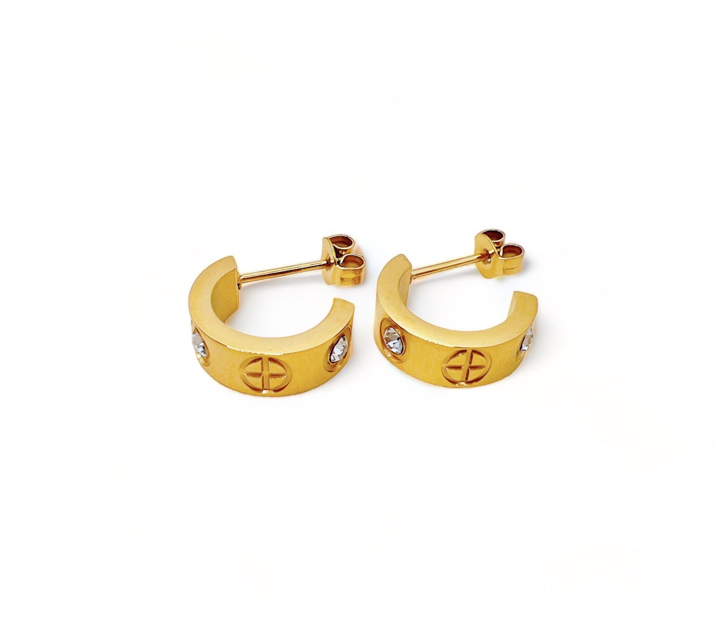 Golden Halo Huggies, pair of gold huggie earrings with cubic zirconia and engraved circle motifs on beige satin
