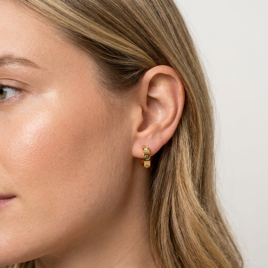 Woman wearing Golden Halo Huggies, gold huggie earring with cubic zirconia, side profile view