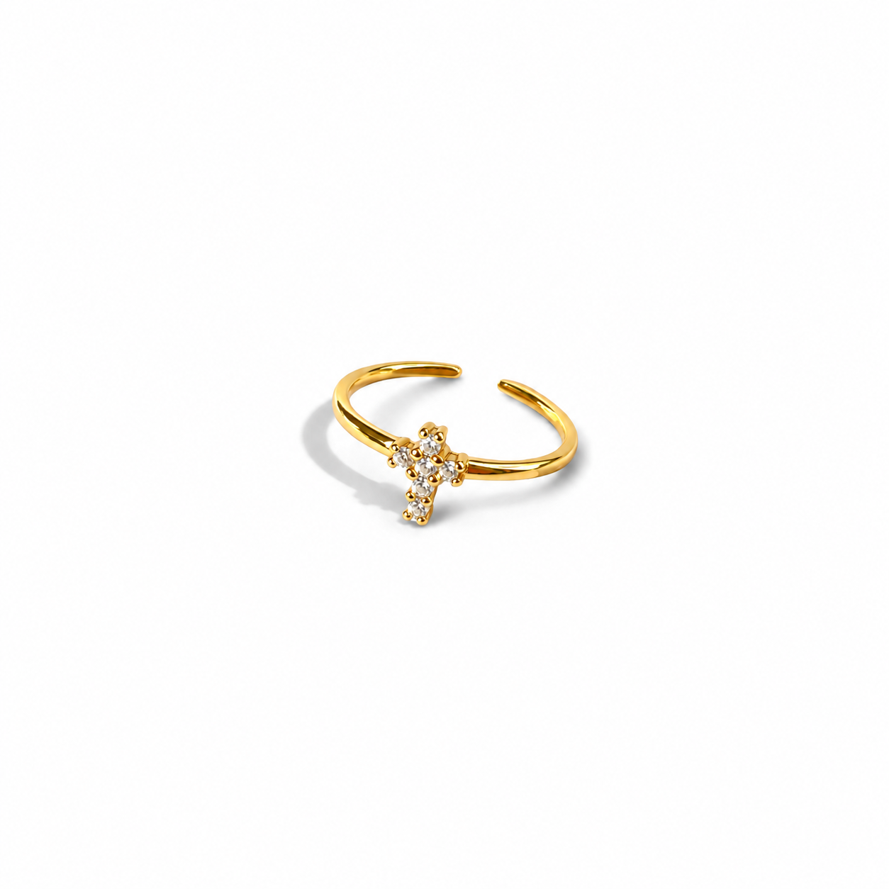 Gold open adjustable cross ring, angled side view on white background