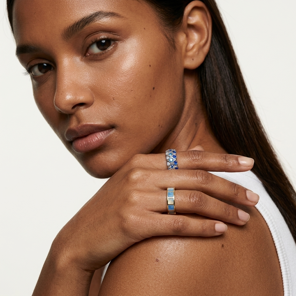 Azure Grid gold-tone open ring with alternating blue and cream square enamel inlays on a white background.